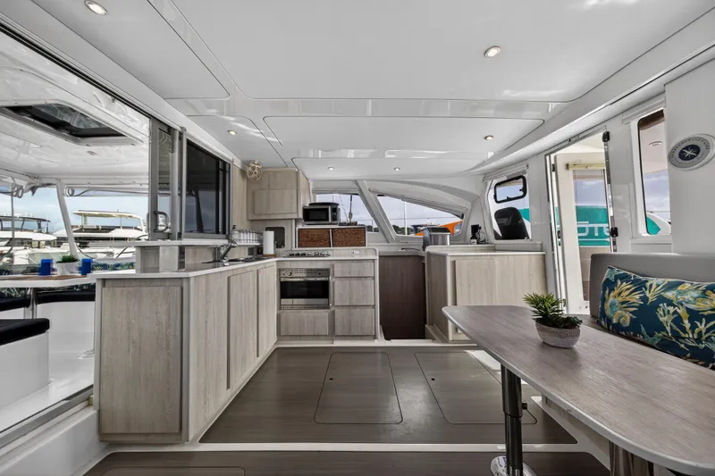  Yacht Photos Pics Luxurious interior of 2016 Leopard 44 Owners Version catamaran with modern kitchen and seating area.