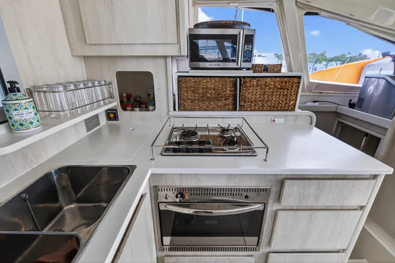 Yacht Photos Pics Modern kitchen in 2016 Leopard 44 Owners Version yacht with stove, oven, and microwave.