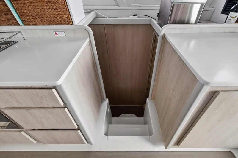  Yacht Photos Pics Interior of 2016 Leopard 44 Owners Version yacht, featuring modern cabinetry and stairs.