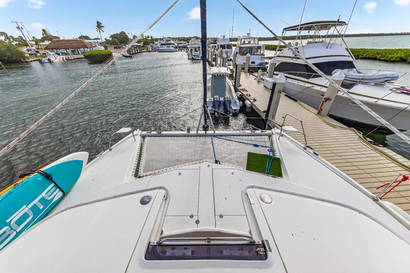  Yacht Photos Pics 2016 Leopard 44 Owners Version catamaran docked with paddleboard on deck.