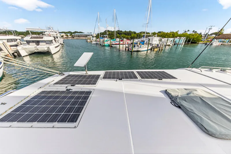  Yacht Photos Pics 2016 Leopard 44 Owners Version catamaran with solar panels docked in a marina.