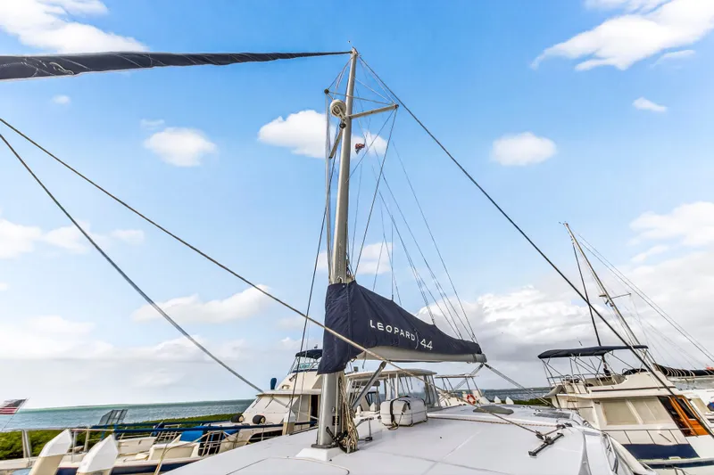  Yacht Photos Pics 2016 Leopard 44 Owners Version catamaran with sails, docked under a blue sky.