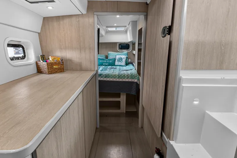  Yacht Photos Pics 2016 Leopard 44 Owners Version yacht interior with cozy bedroom and modern wood finish.