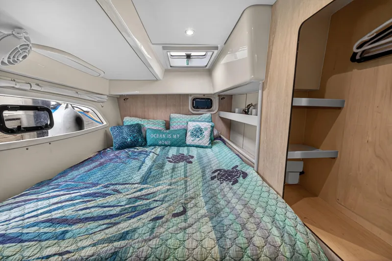  Yacht Photos Pics Cozy bedroom in 2016 Leopard 44 Owners Version yacht with ocean-themed decor.