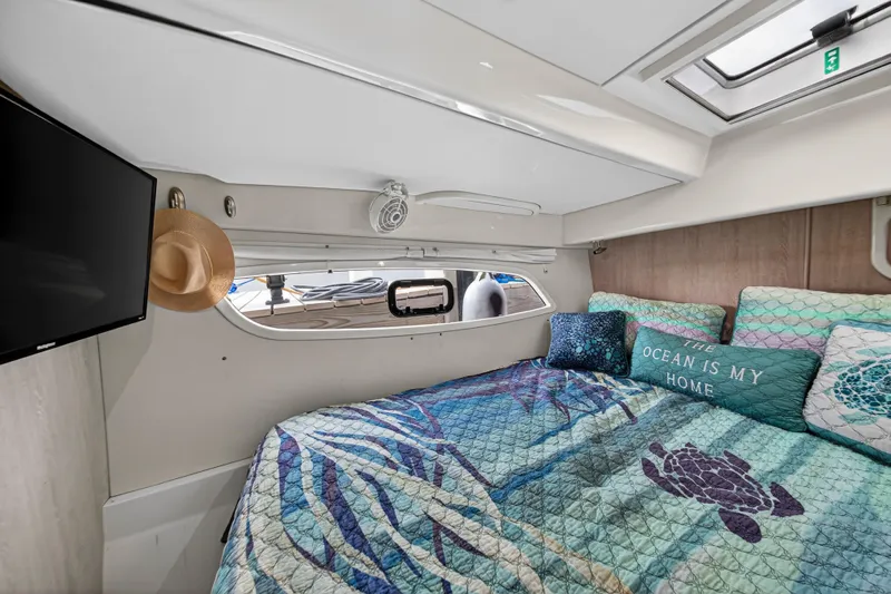  Yacht Photos Pics Cozy cabin interior of 2016 Leopard 44 Owners Version yacht with ocean-themed bedding.