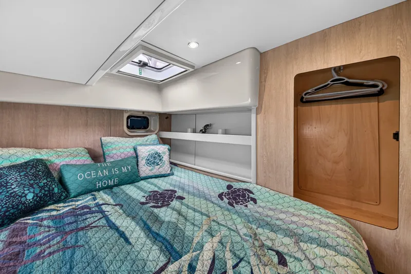  Yacht Photos Pics Cozy bedroom in 2016 Leopard 44 Owners Version yacht with ocean-themed decor.