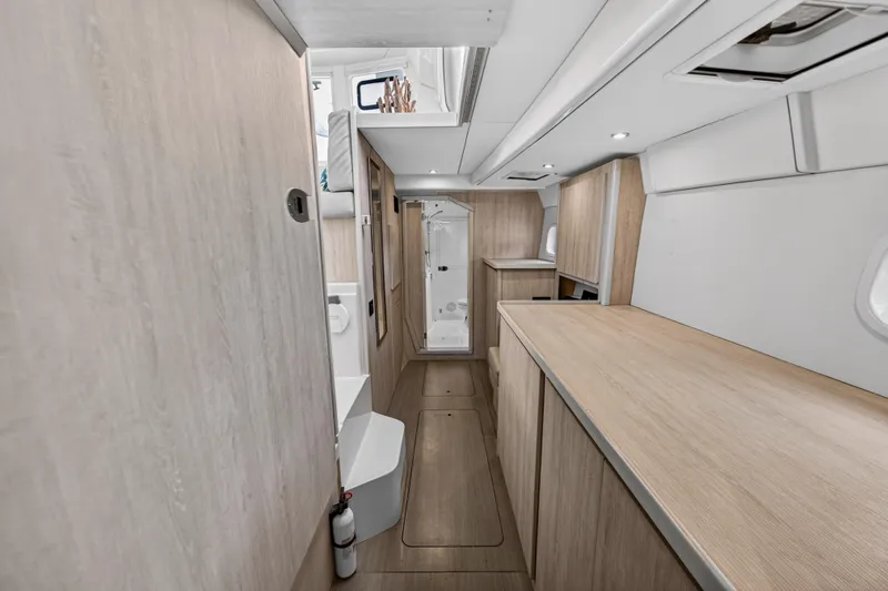  Yacht Photos Pics Interior of 2016 Leopard 44 Owners Version catamaran, featuring modern wood finishes and spacious layout.