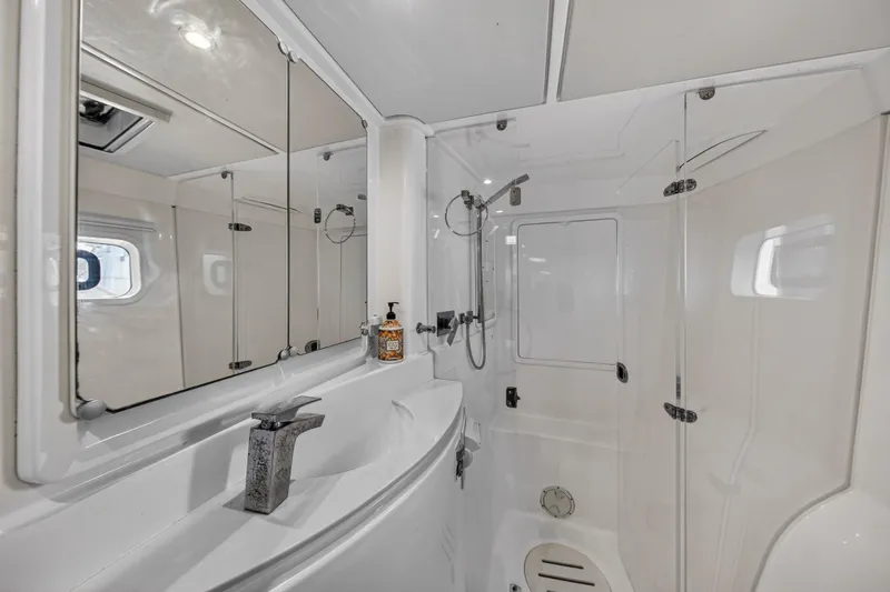  Yacht Photos Pics Luxurious bathroom in 2016 Leopard 44 Owners Version yacht, featuring modern fixtures and spacious design.