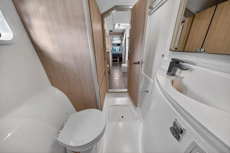  Yacht Photos Pics 2016 Leopard 44 Owners Version yacht bathroom with modern fixtures and wooden accents.