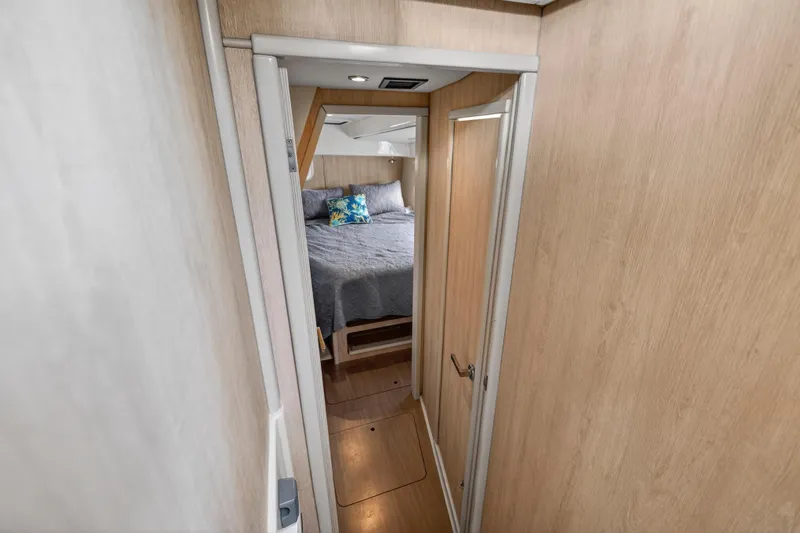  Yacht Photos Pics Interior view of 2016 Leopard 44 Owners Version yacht bedroom with wooden finish.