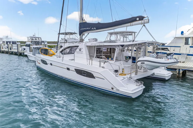  Yacht Photos Pics 2016 Leopard 44 Owners Version catamaran docked at marina, featuring sleek design and spacious deck.