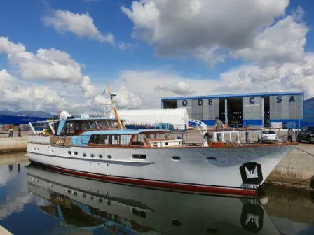  Yacht Photos Pics 1965 Feadship CARAVELLE 23 yacht docked at a marina under a cloudy sky.