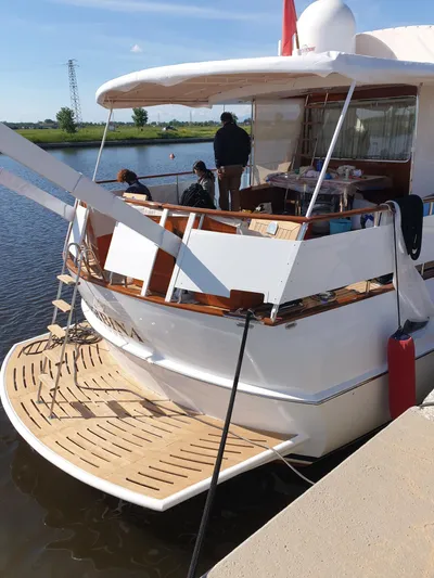  Yacht Photos Pics 1965 Feadship CARAVELLE 23 yacht docked, featuring elegant wooden deck and classic design.