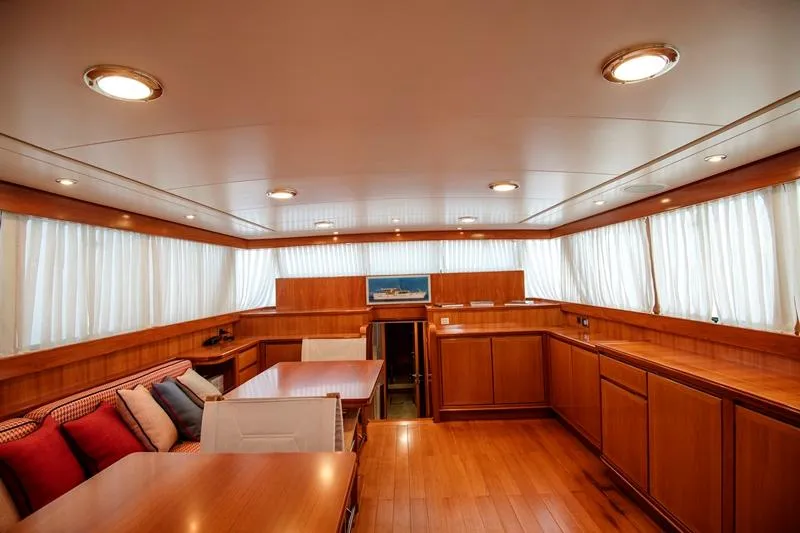  Yacht Photos Pics Luxurious interior of 1965 Feadship CARAVELLE 23 yacht with elegant wood paneling and seating.
