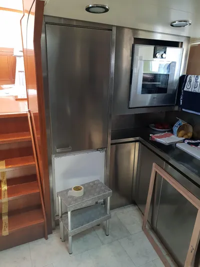  Yacht Photos Pics Interior of 1965 Feadship CARAVELLE 23 yacht kitchen with stainless steel appliances.