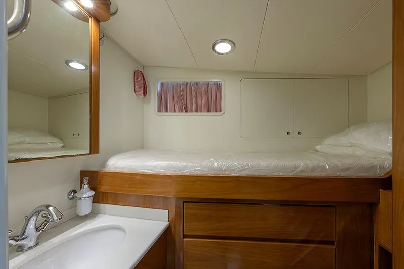 Yacht Photos Pics Cozy cabin interior of 1965 Feadship CARAVELLE 23 yacht with wooden furnishings and compact sink.