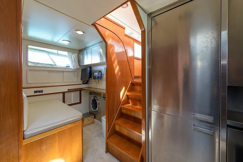  Yacht Photos Pics Interior of 1965 Feadship CARAVELLE 23 yacht with wooden stairs and modern amenities.