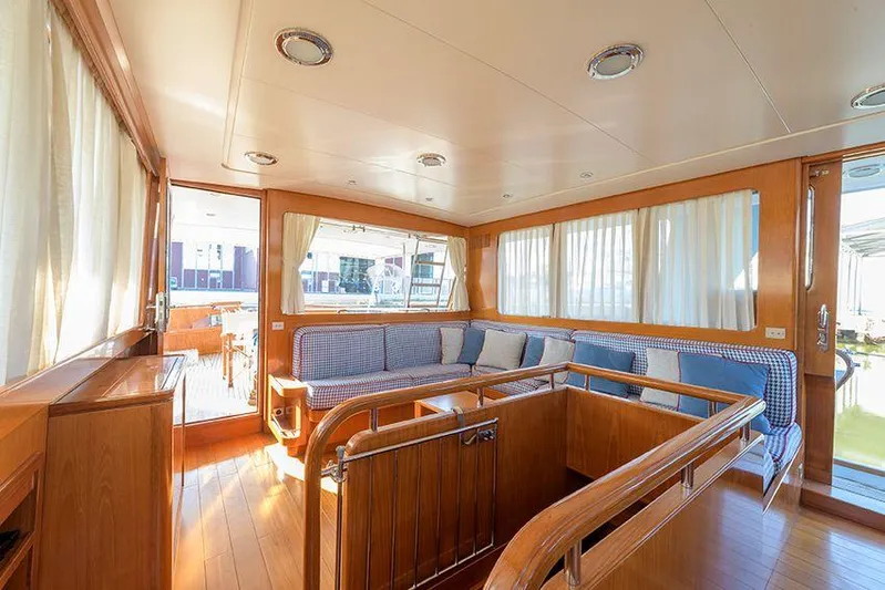  Yacht Photos Pics Luxurious interior of 1965 Feadship CARAVELLE 23 yacht with elegant wood finishes and seating.