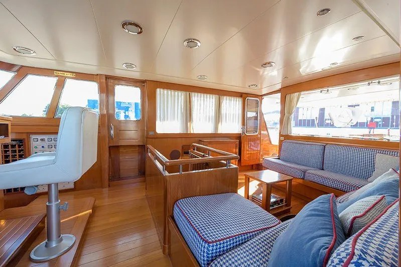  Yacht Photos Pics Luxurious interior of 1965 Feadship CARAVELLE 23 yacht with elegant wood and plush seating.