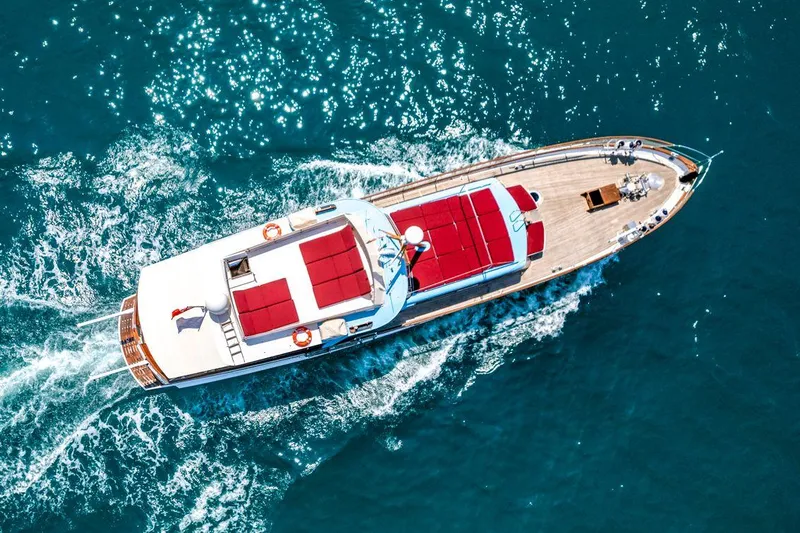  Yacht Photos Pics Aerial view of 1965 Feadship CARAVELLE 23 yacht cruising on blue ocean waters.