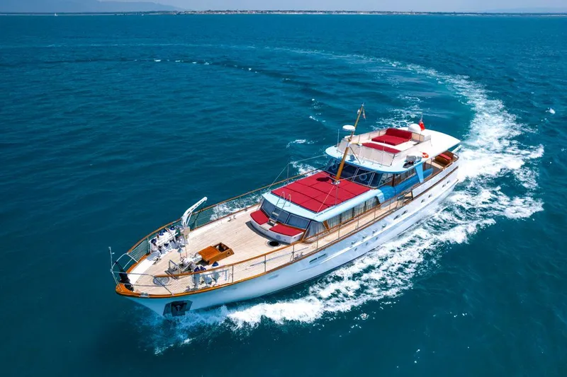  Yacht Photos Pics 1965 Feadship CARAVELLE 23 yacht cruising on open blue sea.