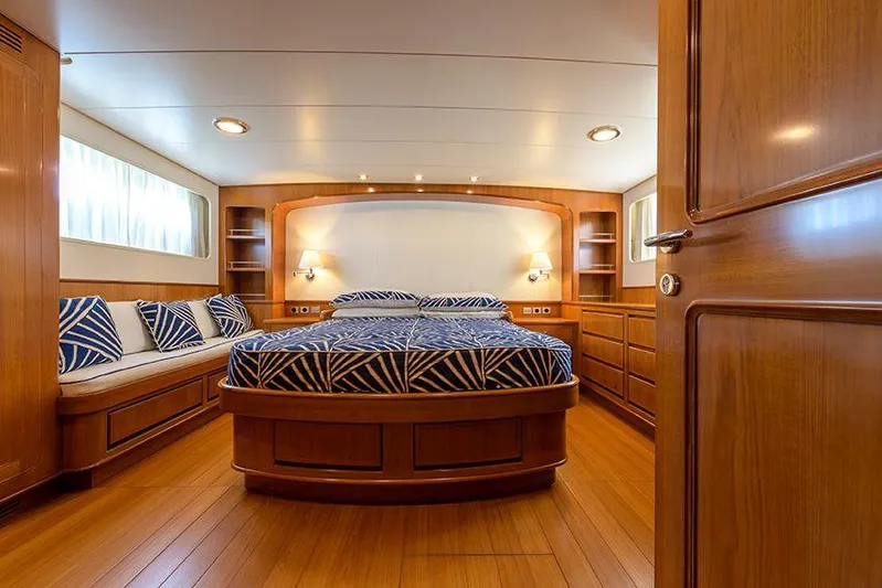  Yacht Photos Pics Luxurious cabin interior of 1965 Feadship CARAVELLE 23 yacht with wood finish and cozy bed.
