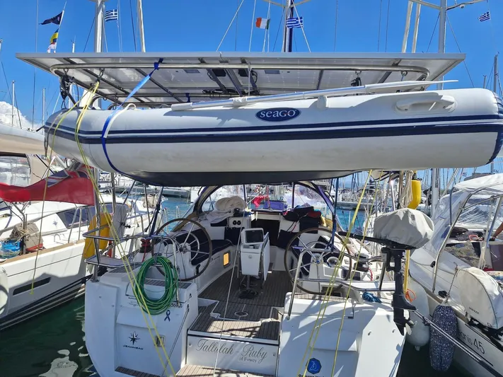  Yacht Photos Pics Jeanneau Sun Odyssey 439 performance yacht, 2013, with dinghy on deck, docked in marina.