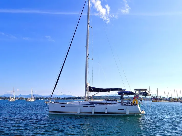  Yacht Photos Pics 2013 Jeanneau Sun Odyssey 439 Performance sailboat on calm blue water.