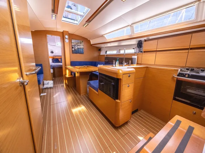 Yacht Photos Pics Interior of 2013 Jeanneau Sun Odyssey 439 performance yacht, featuring wood finish and modern amenities.