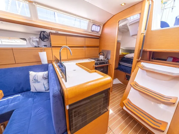  Yacht Photos Pics Interior of 2013 Jeanneau Sun Odyssey 439 sailboat with modern kitchen and seating area.