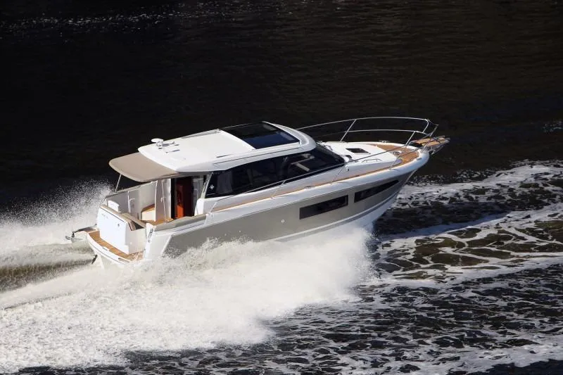  Yacht Photos Pics Manufacturer Provided Image: 2017 Jeanneau NC 9 motor yacht cruising on water.