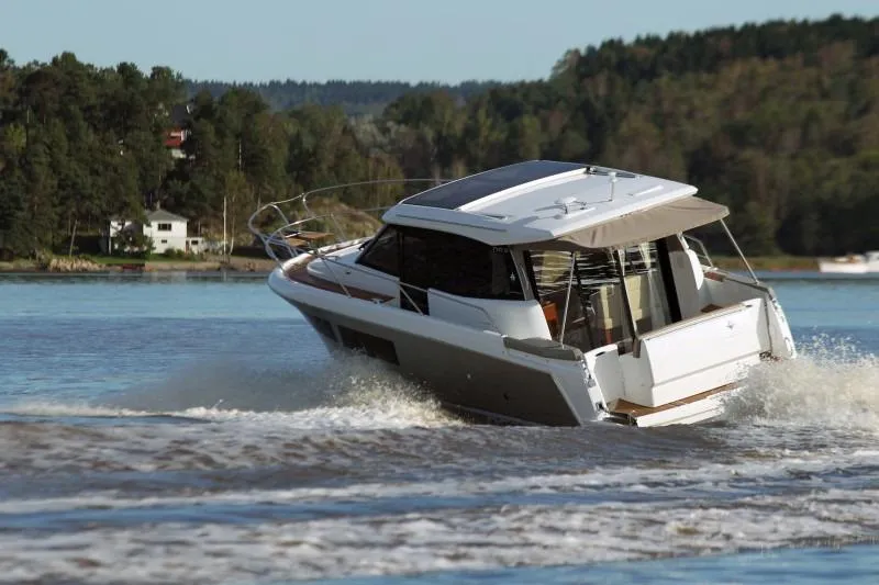  Yacht Photos Pics Manufacturer Provided Image: 2017 Jeanneau NC 9 motor yacht cruising on a scenic lake.