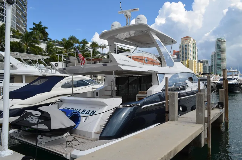 Cerulean Yacht Photos Pics 2018 Azimut 66 yacht docked at a marina with cityscape background.