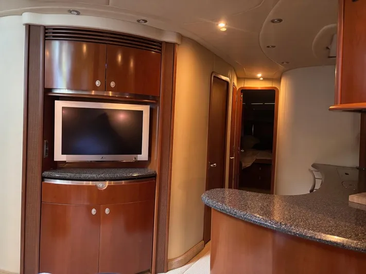 Tradition Yacht Photos Pics Interior of 2005 Sea Ray 500 Sundancer yacht with TV and wood cabinetry.