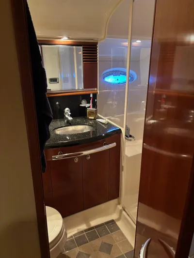 Tradition Yacht Photos Pics Luxurious bathroom in 2005 Sea Ray 500 Sundancer yacht with modern fixtures and wood accents.