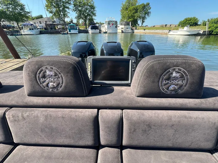  Yacht Photos Pics 2006 Donzi 38 ZFX boat interior with Lowrance display, docked by the water.