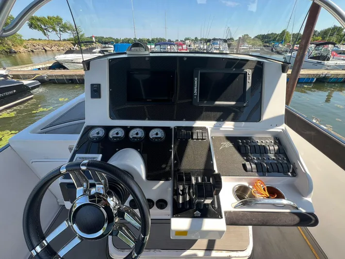  Yacht Photos Pics 2006 Donzi 38 ZFX boat dashboard with steering wheel and control panels at marina.