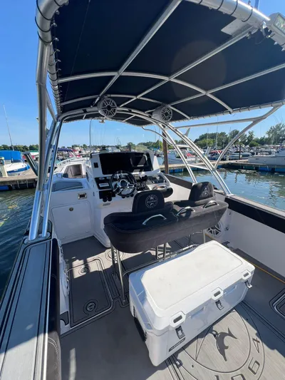  Yacht Photos Pics 2006 Donzi 38 ZFX boat interior with steering wheel and seating, docked at marina.