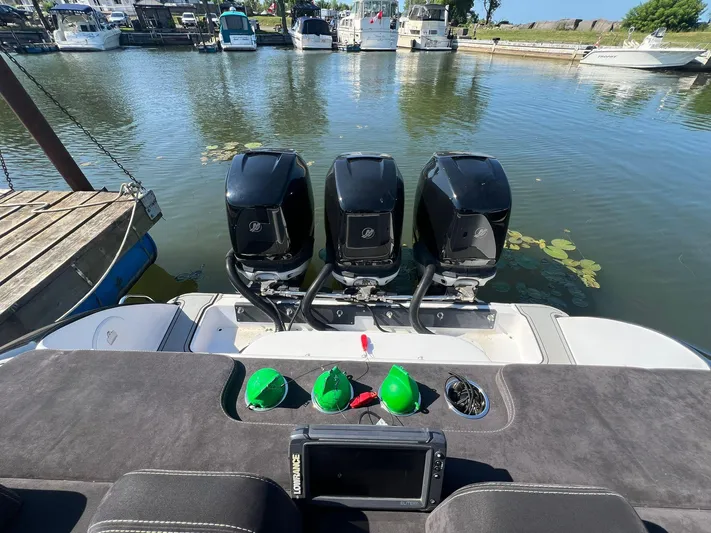  Yacht Photos Pics 2006 Donzi 38 ZFX boat with triple outboard engines docked at a marina.