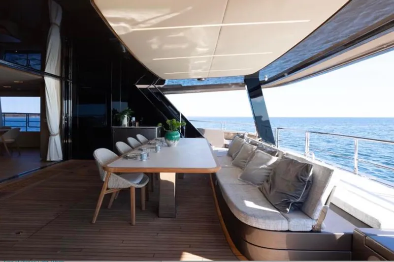 Twilight Yacht Photos Pics Luxurious Sunreef 100 Power yacht deck with elegant dining area, ocean view, 2025 model.