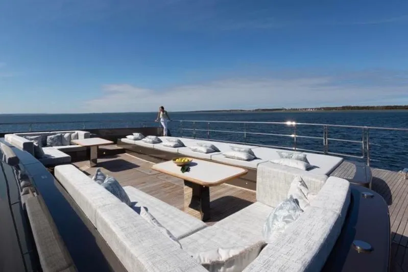 Twilight Yacht Photos Pics Luxurious Sunreef 100 Power yacht deck with elegant seating, ocean view, 2025 model.