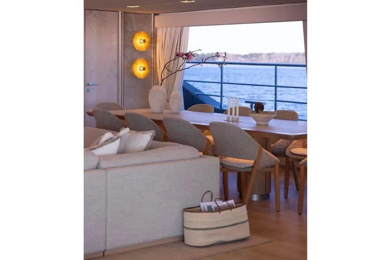 Twilight Yacht Photos Pics Luxurious interior of 2025 Sunreef 100 Power yacht with elegant dining area and sea view.
