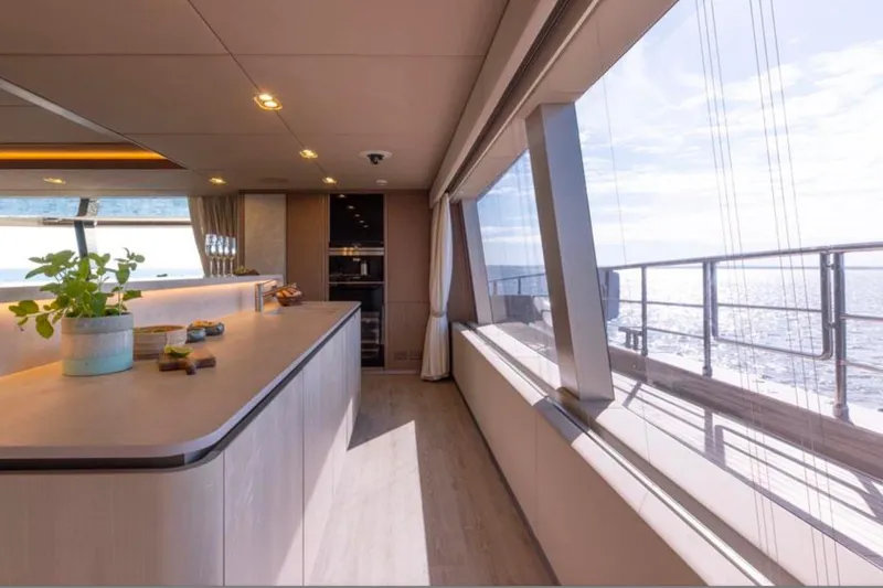 Twilight Yacht Photos Pics Luxurious interior of 2025 Sunreef 100 Power yacht with panoramic ocean views.