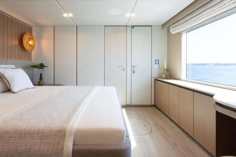 Twilight Yacht Photos Pics Luxurious Sunreef 100 Power 2025 yacht bedroom with ocean view and elegant decor.