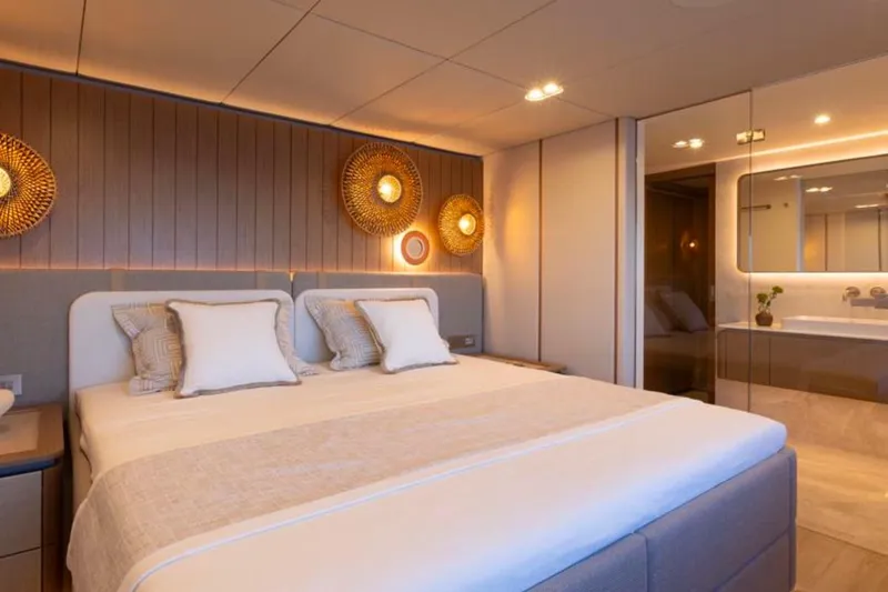 Twilight Yacht Photos Pics Luxurious bedroom interior of 2025 Sunreef 100 Power yacht with modern decor and ambient lighting.