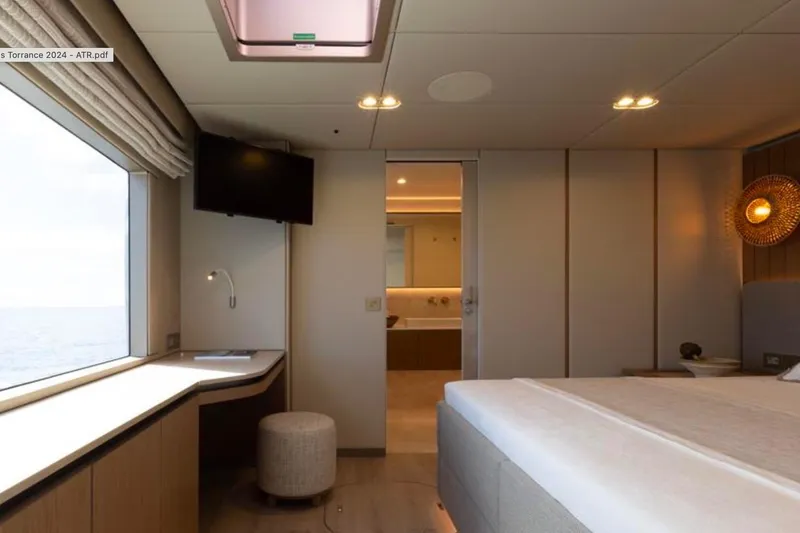 Twilight Yacht Photos Pics Luxurious interior of 2025 Sunreef 100 Power yacht, featuring elegant bedroom and ocean view.