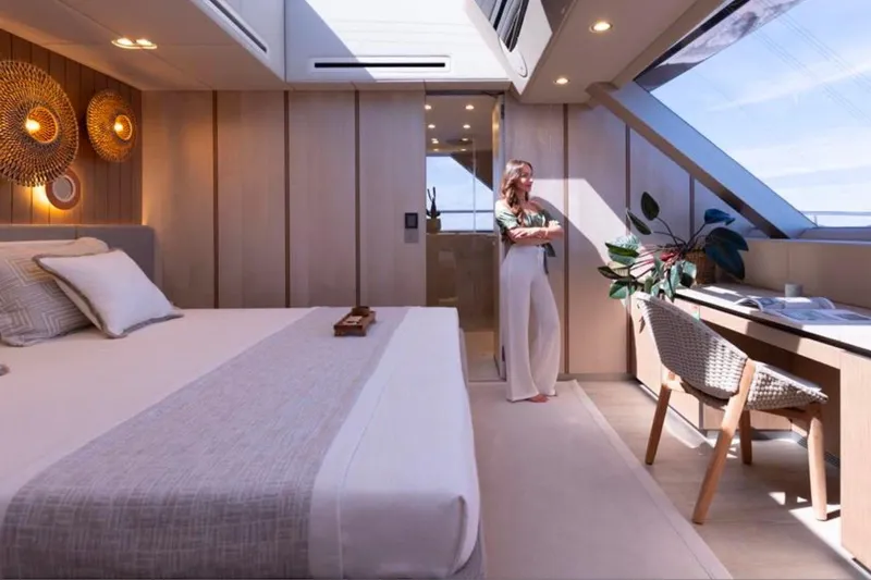 Twilight Yacht Photos Pics Luxurious Sunreef 100 Power 2025 yacht bedroom with modern decor and large windows.