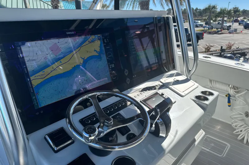  Yacht Photos Pics 2023 Freeman 42LR boat dashboard with navigation display and steering wheel.