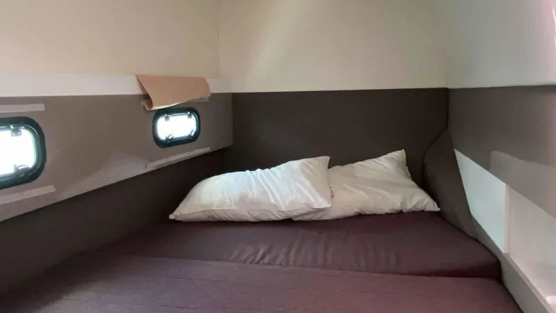  Yacht Photos Pics Interior of Bali 4.1 yacht, cozy bedroom with pillows.