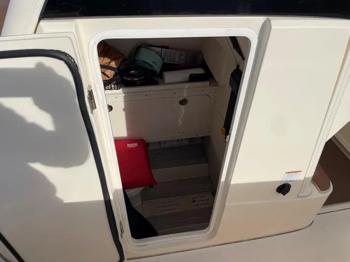  Yacht Photos Pics 2020 Ocean Scout 277 cabin interior with open door, showing storage and equipment.